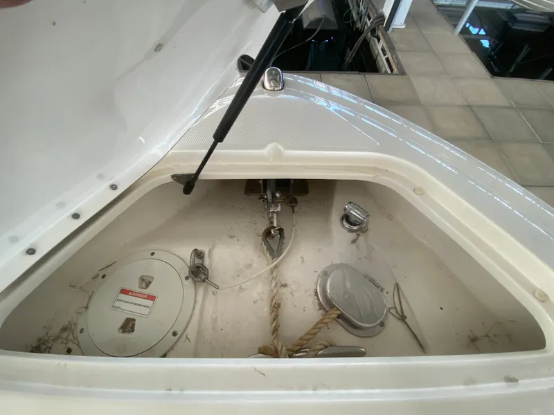 Slide: The Image of 2012 Sea Ray 270 SLX anchor compartment with rope and hatch open. - 43