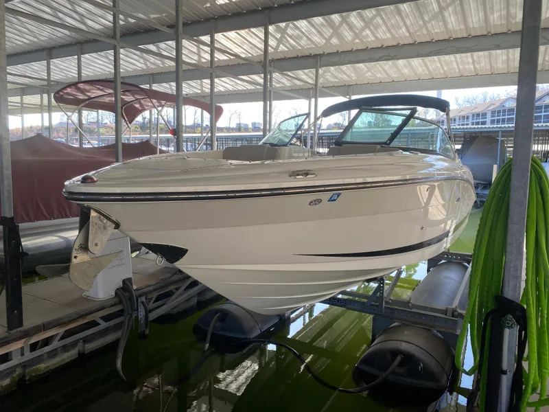 Slide: The Image of 2012 Sea Ray 270 SLX boat docked in a covered marina. - 49