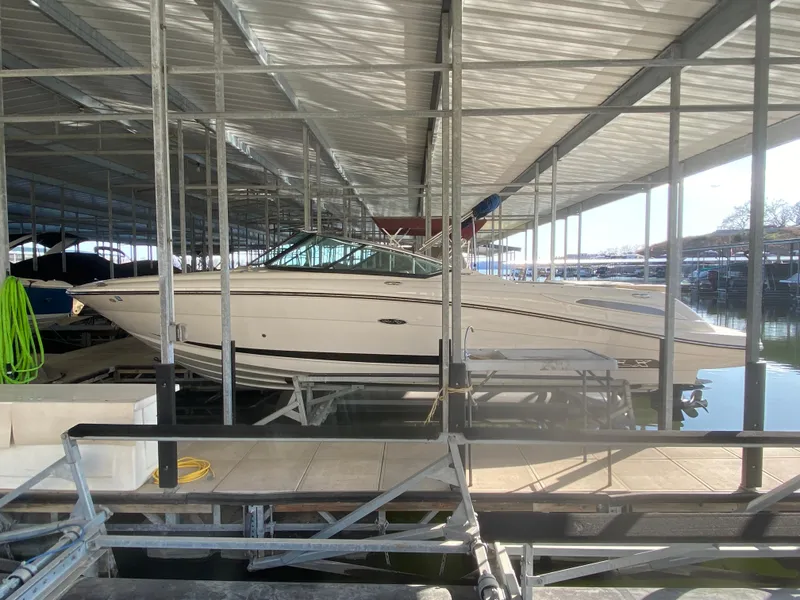Slide: The Image of 2012 Sea Ray 270 SLX boat docked in a covered marina. - 9