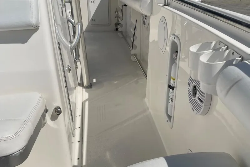 Slide: The Image of Interior view of a 2007 Edgewater 228 boat, featuring seating and storage compartments. - 10