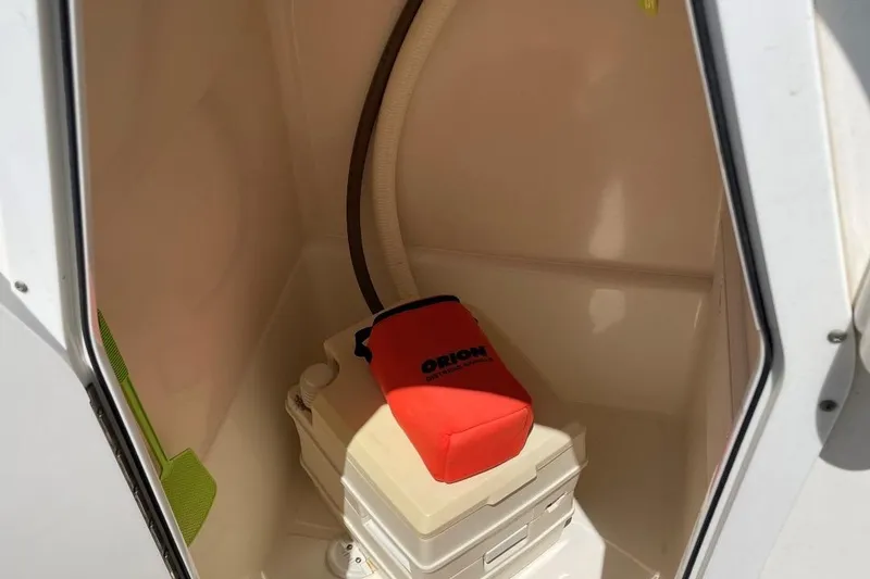 Slide: The Image of Portable toilet inside 2007 Edgewater 228 boat cabin with red cover. - 12