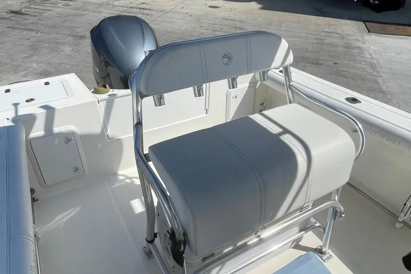 Slide: The Image of 2007 Edgewater 228 boat interior with seating and outboard motor. - 13