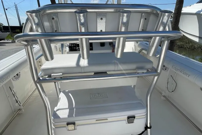 Slide: The Image of 2007 Edgewater 228 boat interior with rod holders and cooler storage. - 14