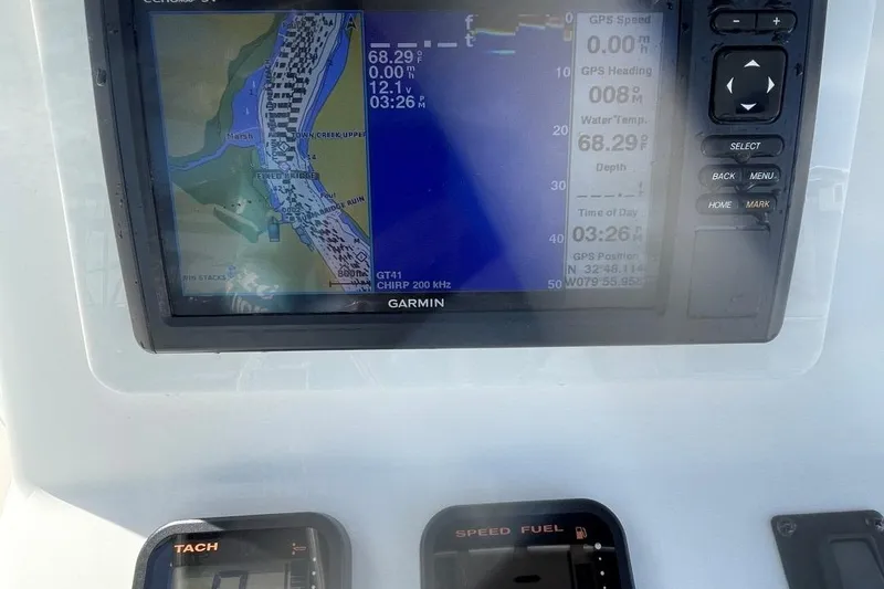 Slide: The Image of Garmin navigation system on 2007 Edgewater 228 boat dashboard, displaying map and data. - 17