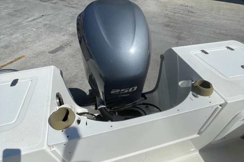 Slide: The Image of 2007 Edgewater 228 boat with a 250 horsepower outboard motor, viewed from the rear. - 23