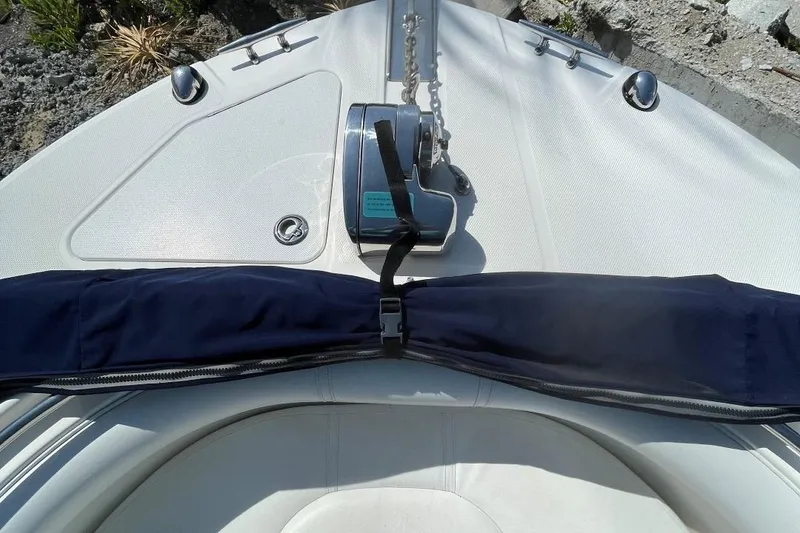 Slide: The Image of Bow of 2007 Edgewater 228 boat with anchor and blue cover. - 7