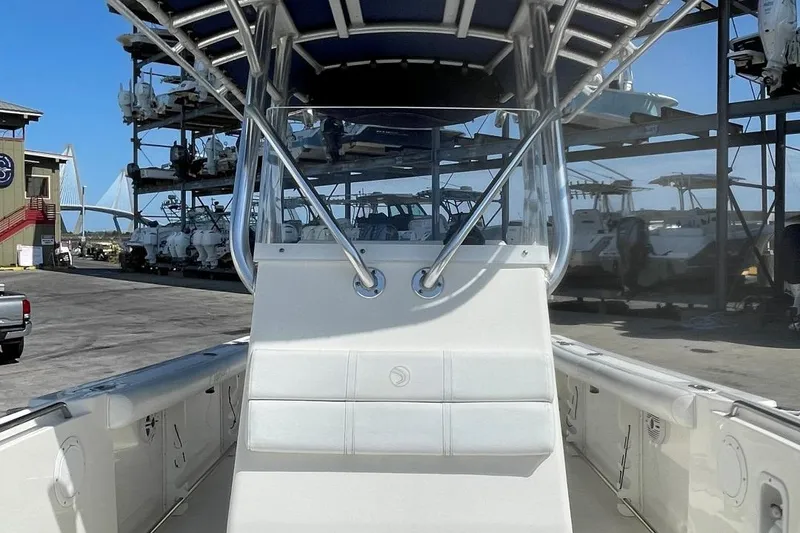 Slide: The Image of 2007 Edgewater 228 boat with T-top, docked in a marina under clear blue sky. - 9