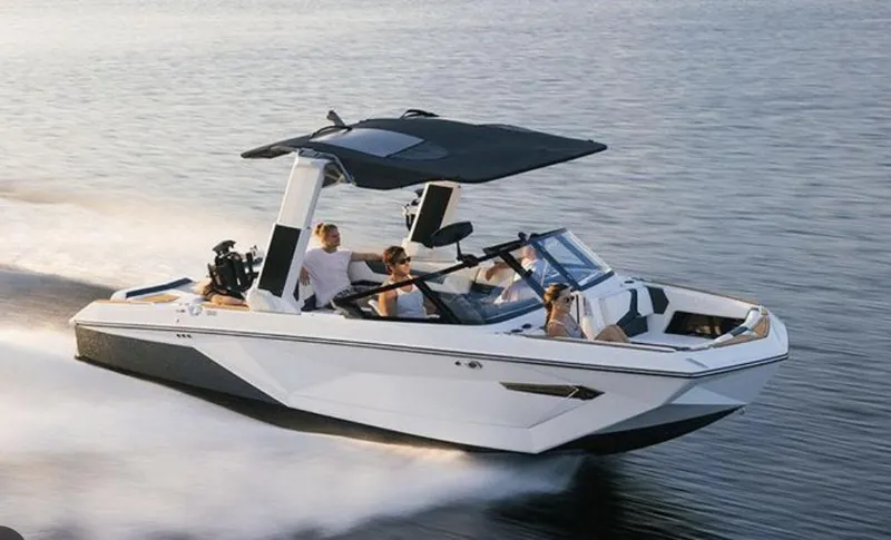 Slide: The Image of 2022 Nautique Super Air Nautique G23 speeding on water with passengers. - 4