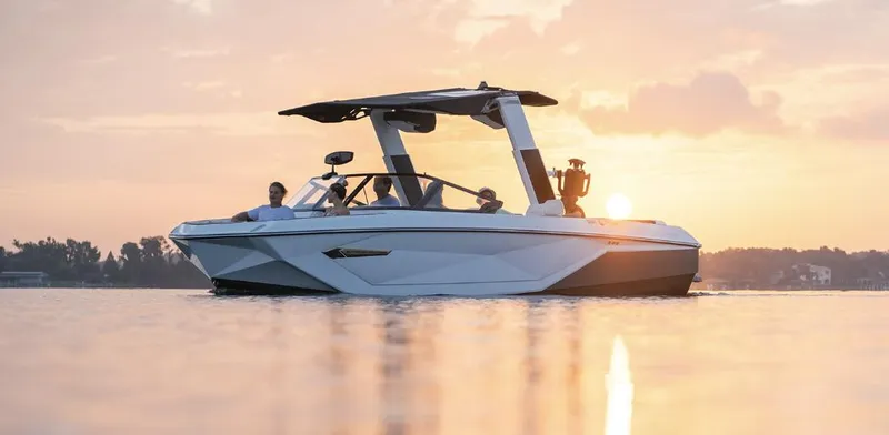Slide: The Image of 2022 Nautique Super Air Nautique G23 boat on calm water at sunset. - 5