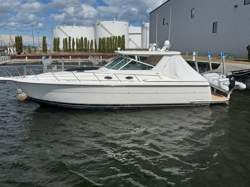 The Image of 2000 Tiara Yachts 4000 Express docked near industrial buildings. - 0