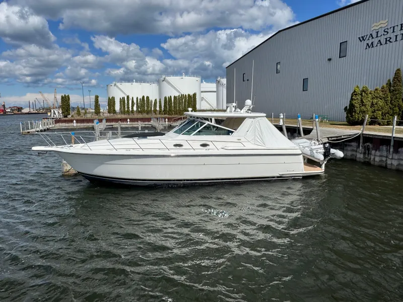 Slide: The Image of 2000 Tiara Yachts 4000 Express docked at a marina under a cloudy sky. - 1