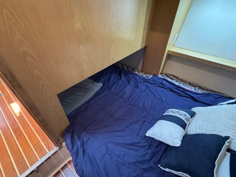 Slide: The Image of 2000 Tiara Yachts 4000 Express cabin with cozy bed and wooden interior. - 10