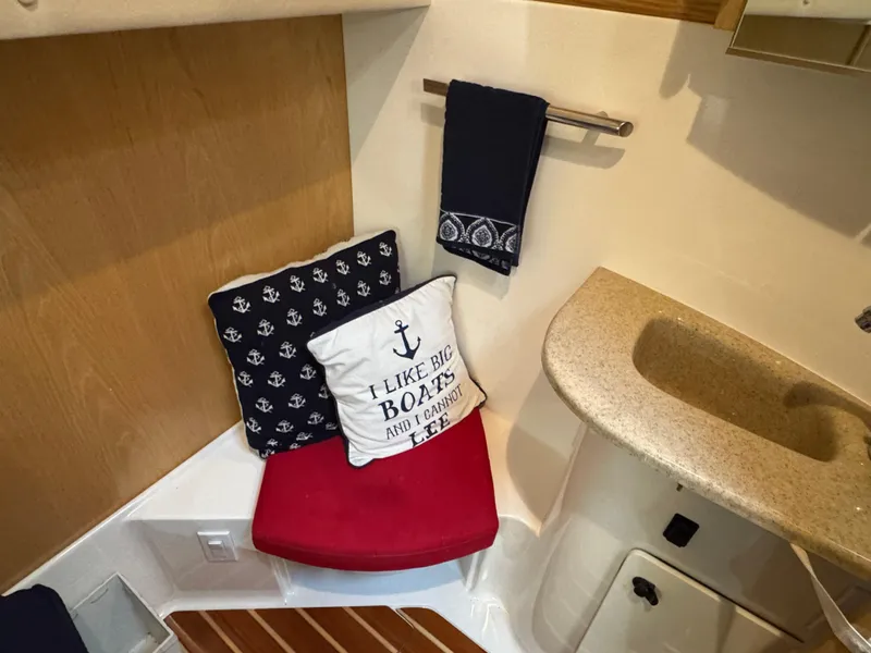 Slide: The Image of 2000 Tiara Yachts 4000 Express interior with nautical-themed cushions and compact sink area. - 11