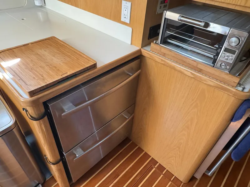 Slide: The Image of Kitchen area of 2000 Tiara Yachts 4000 Express with stainless steel appliances. - 12