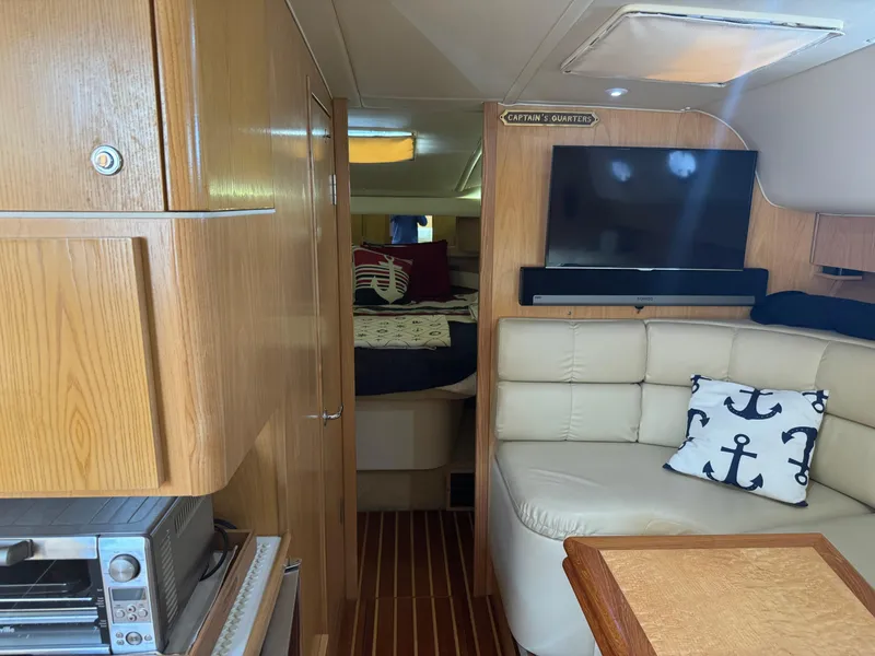 Slide: The Image of Interior of 2000 Tiara Yachts 4000 Express with cozy seating and nautical decor. - 14