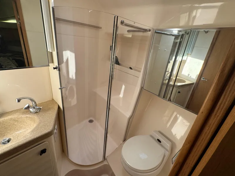 Slide: The Image of Bathroom interior of 2000 Tiara Yachts 4000 Express with shower, sink, and toilet. - 17