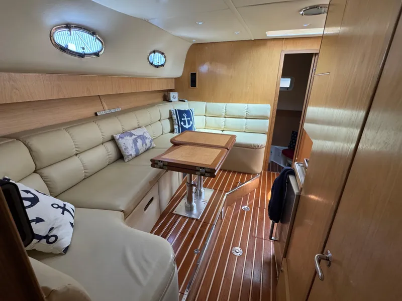 Slide: The Image of 2000 Tiara Yachts 4000 Express interior with beige seating and wooden accents. - 19
