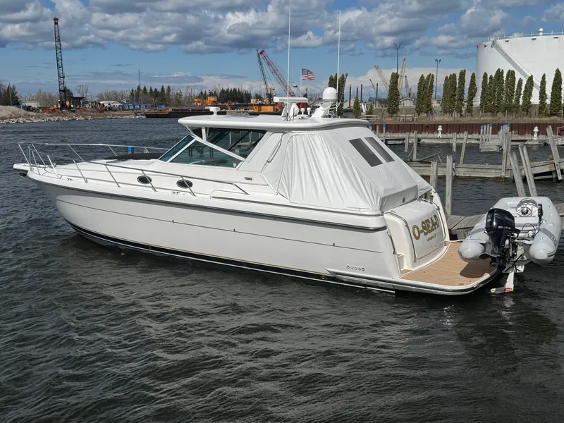 Slide: The Image of 2000 Tiara Yachts 4000 Express docked in a marina under cloudy skies. - 2