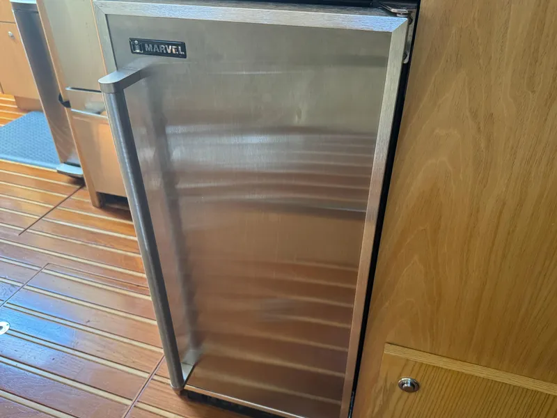 Slide: The Image of Stainless steel refrigerator on 2000 Tiara Yachts 4000 Express with wooden flooring. - 20