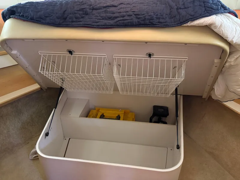 Slide: The Image of Under-bed storage in 2000 Tiara Yachts 4000 Express, featuring wire baskets and organized compartments. - 21