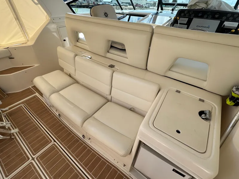 Slide: The Image of Luxury seating on 2000 Tiara Yachts 4000 Express with beige upholstery and wood flooring. - 22