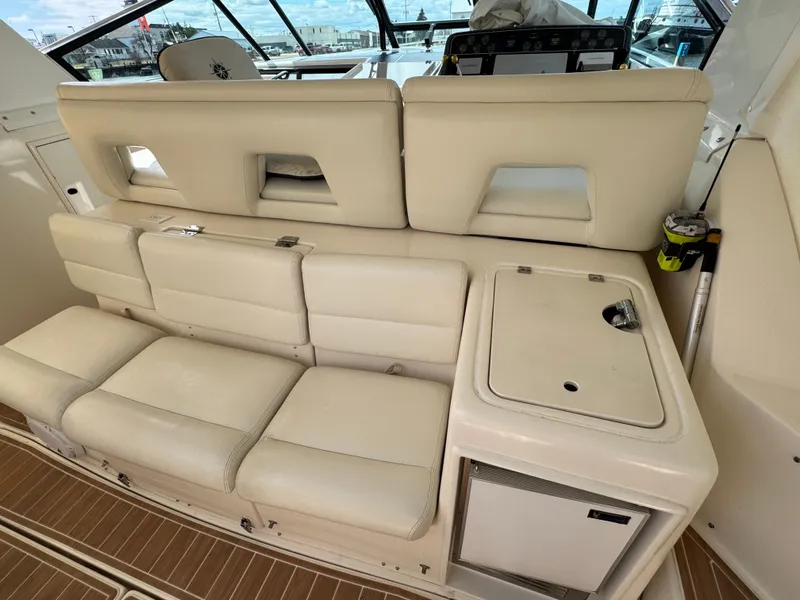 Slide: The Image of 2000 Tiara Yachts 4000 Express interior with beige seating and compact kitchenette. - 23