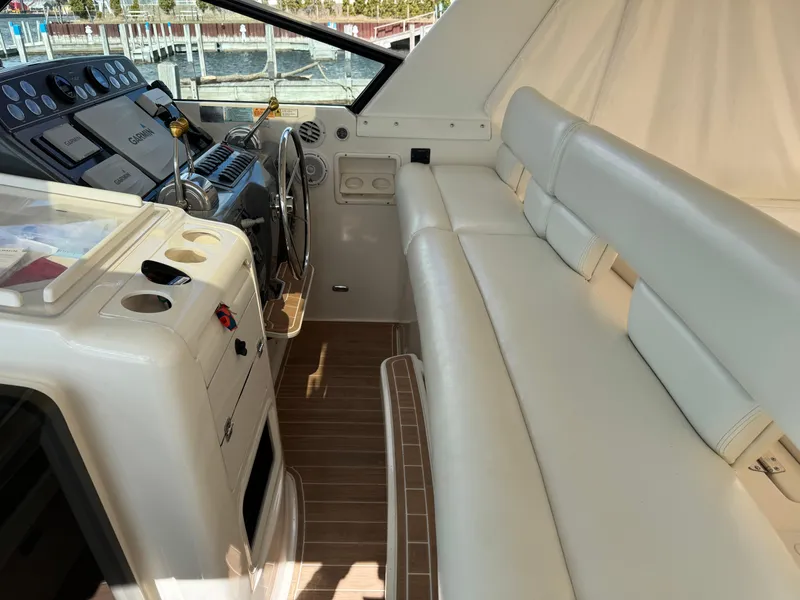 Slide: The Image of Interior of 2000 Tiara Yachts 4000 Express with white seating and control panel. - 24