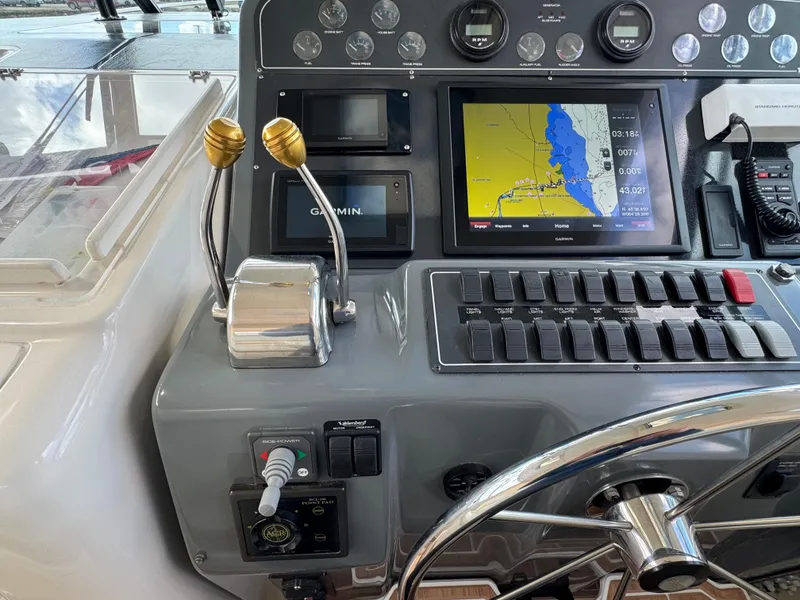 Slide: The Image of Control panel of a 2000 Tiara Yachts 4000 Express with navigation and throttle controls. - 27