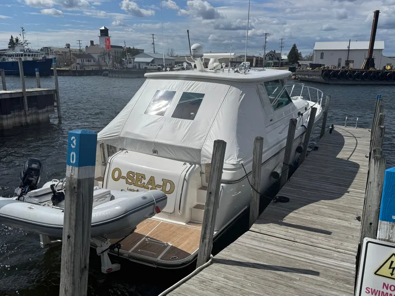 Slide: The Image of 2000 Tiara Yachts 4000 Express docked at a marina with inflatable boat. - 3