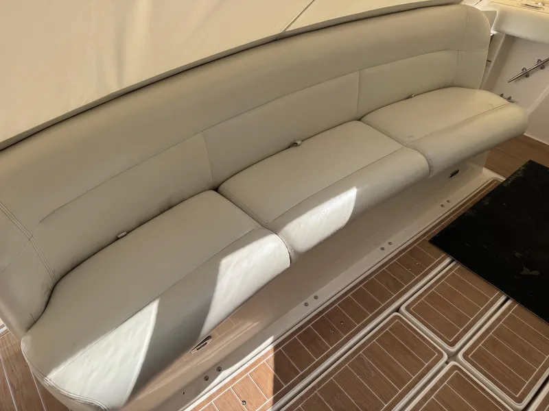 Slide: The Image of Luxury seating on 2000 Tiara Yachts 4000 Express, featuring beige upholstery and wooden flooring. - 35