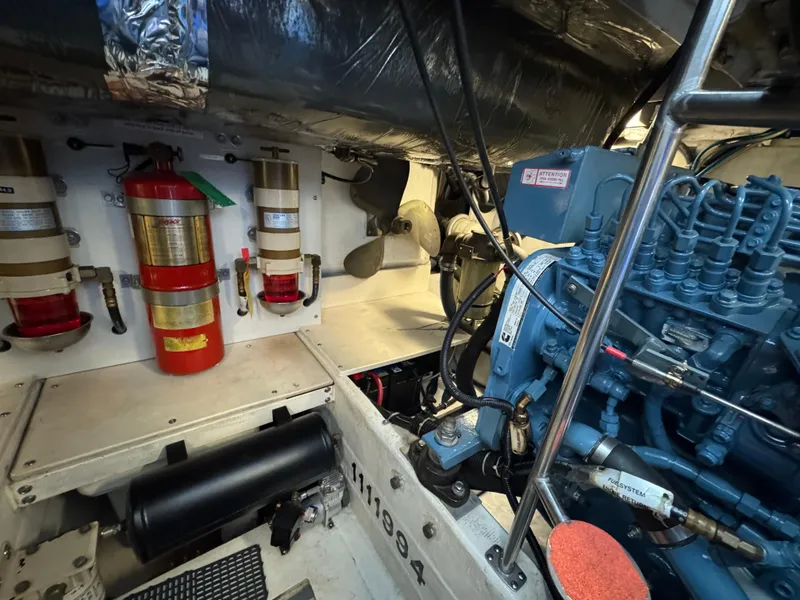Slide: The Image of Engine room of a 2000 Tiara Yachts 4000 Express, featuring fire extinguishers and machinery. - 40