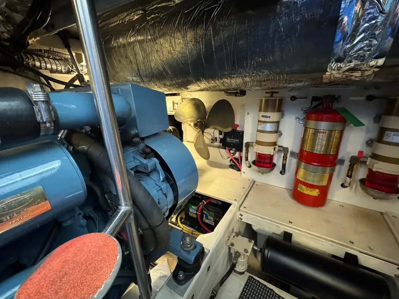 Slide: The Image of Engine room of 2000 Tiara Yachts 4000 Express, featuring machinery and fire safety equipment. - 41
