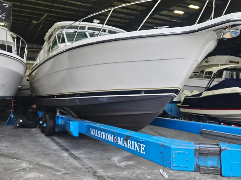 Slide: The Image of 2000 Tiara Yachts 4000 Express on blue Walstrom Marine trailer in storage facility. - 43