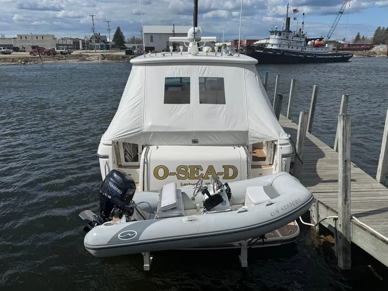 Slide: The Image of 2000 Tiara Yachts 4000 Express docked with inflatable boat attached. - 44