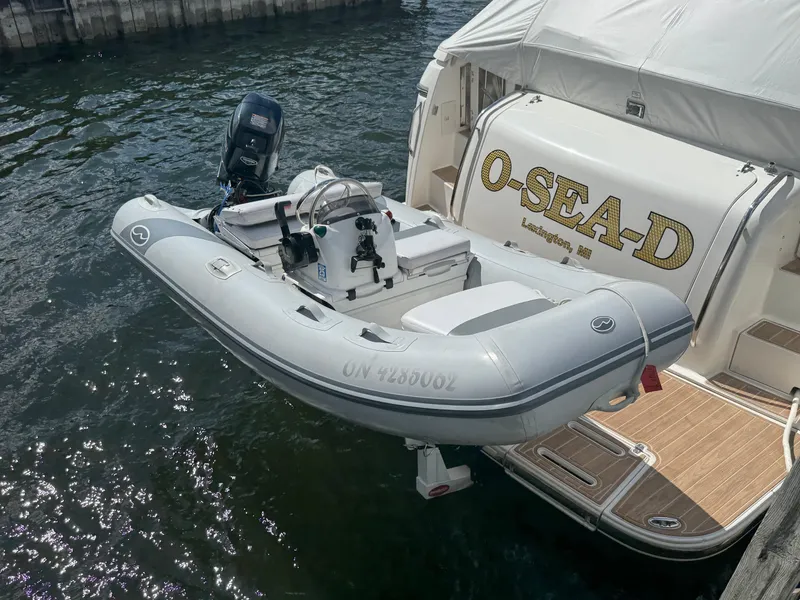 Slide: The Image of A 2000 Tiara Yachts 4000 Express with a small inflatable boat attached at the stern. - 45