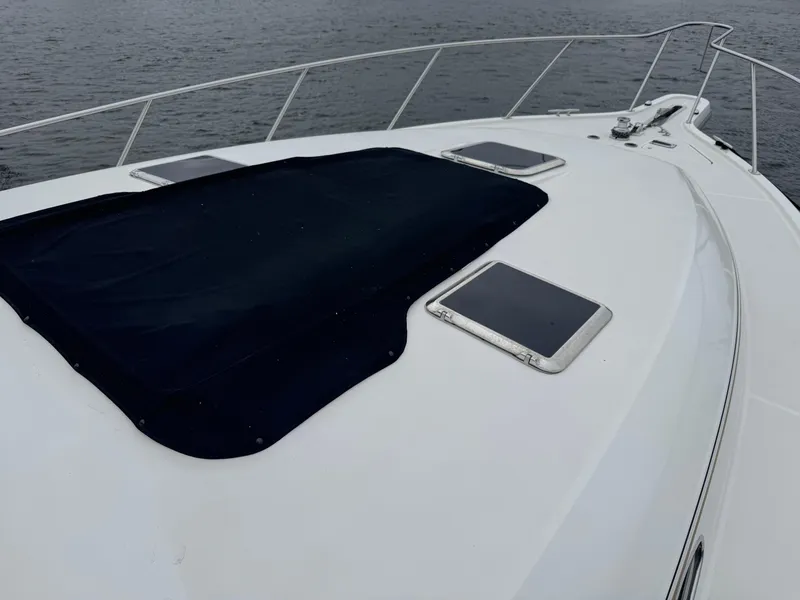 Slide: The Image of Bow of 2000 Tiara Yachts 4000 Express with black cover and hatches. - 46