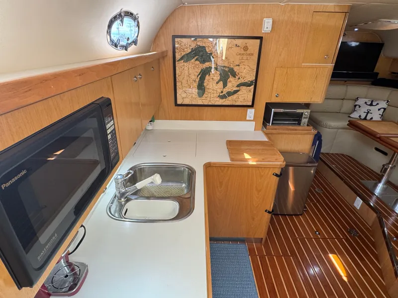 Slide: The Image of Interior of 2000 Tiara Yachts 4000 Express with kitchenette and nautical map. - 6