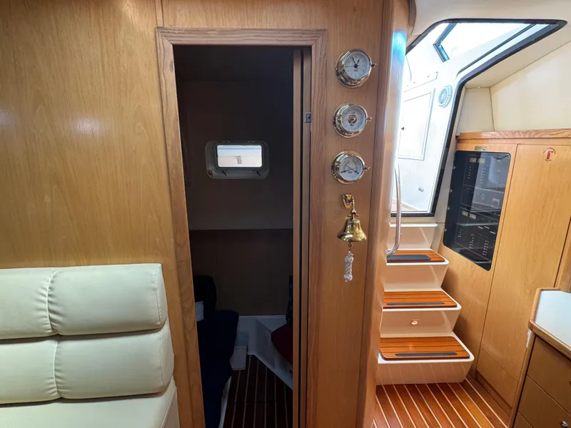 Slide: The Image of Interior of 2000 Tiara Yachts 4000 Express with wooden paneling and nautical decor. - 8