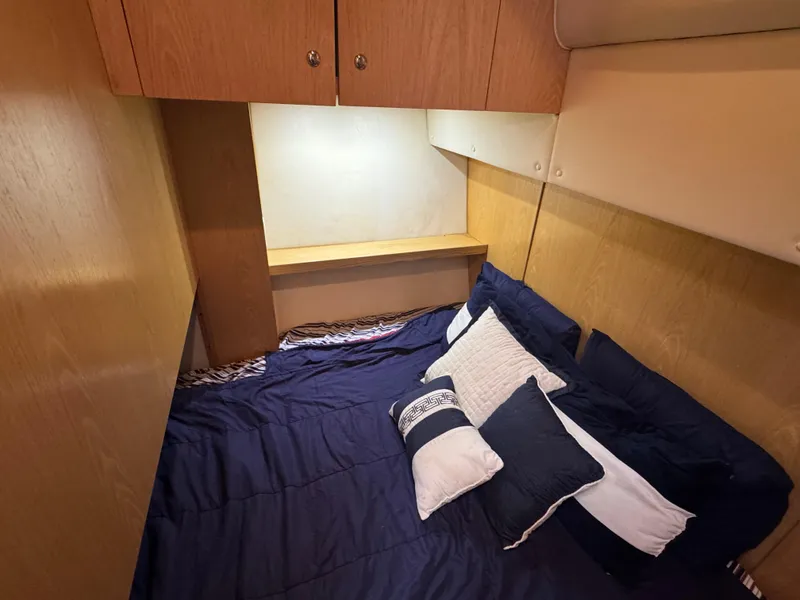 Slide: The Image of Cozy cabin interior of 2000 Tiara Yachts 4000 Express with bed and pillows. - 9
