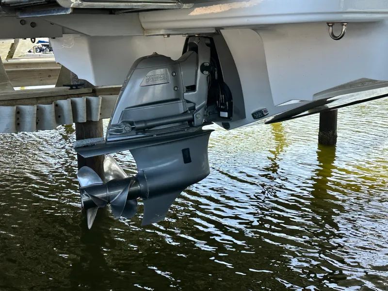 Slide: The Image of 2023 Four Winns HD8 boat outdrive in water, showcasing propeller and hull design. - 10