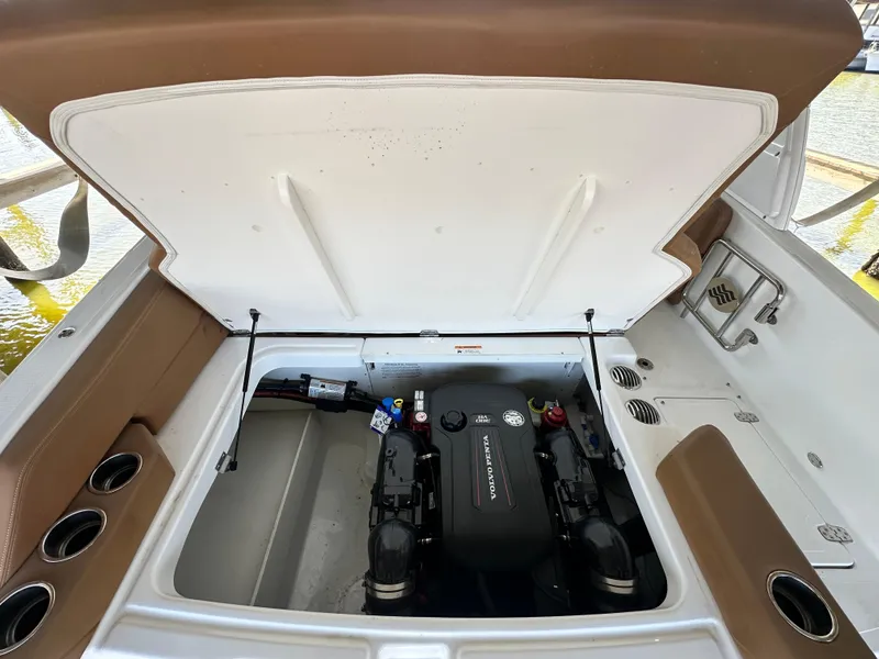 Slide: The Image of 2023 Four Winns HD8 boat engine compartment with open hatch, showcasing engine details. - 14