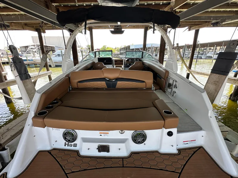 Slide: The Image of 2023 Four Winns HD8 boat interior with brown seating and modern design. - 15