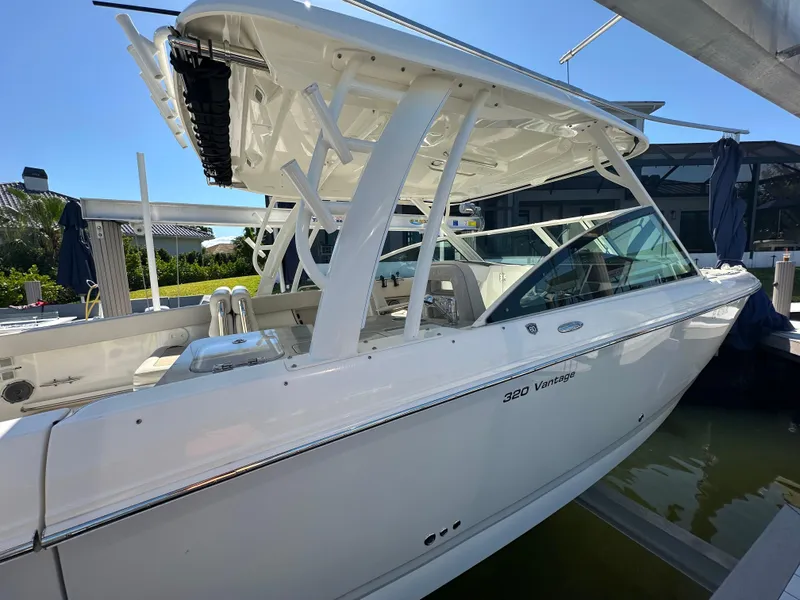 Slide: The Image of 2018 Boston Whaler 320 Vantage docked by a scenic waterfront. - 11
