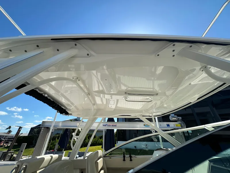 Slide: The Image of 2018 Boston Whaler 320 Vantage boat interior with seating and helm station. - 13