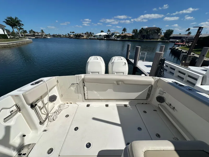 Slide: The Image of 2018 Boston Whaler 320 Vantage interior cabin with open door and life jacket. - 15