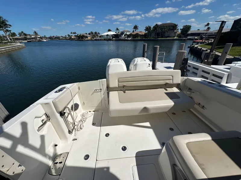 Slide: The Image of Interior view of 2018 Boston Whaler 320 Vantage boat with seating and open hatch. - 16