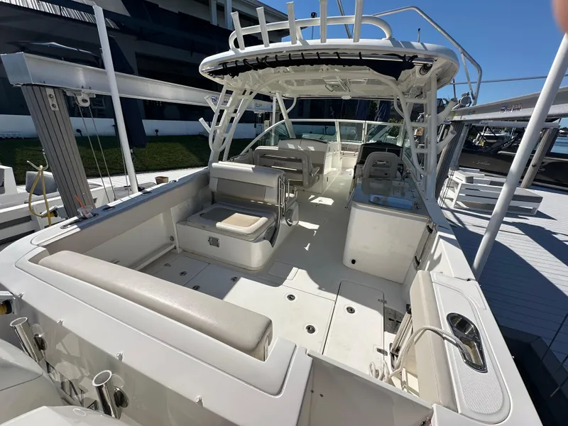 Slide: The Image of 2018 Boston Whaler 320 Vantage boat interior with helm and seating area. - 17