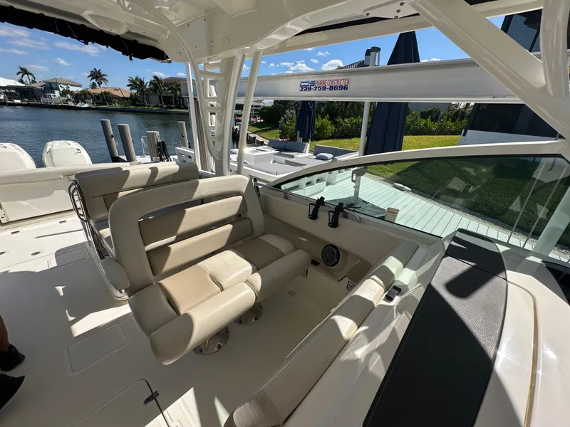 Slide: The Image of 2018 Boston Whaler 320 Vantage interior cabin with toilet and wooden accents. - 19