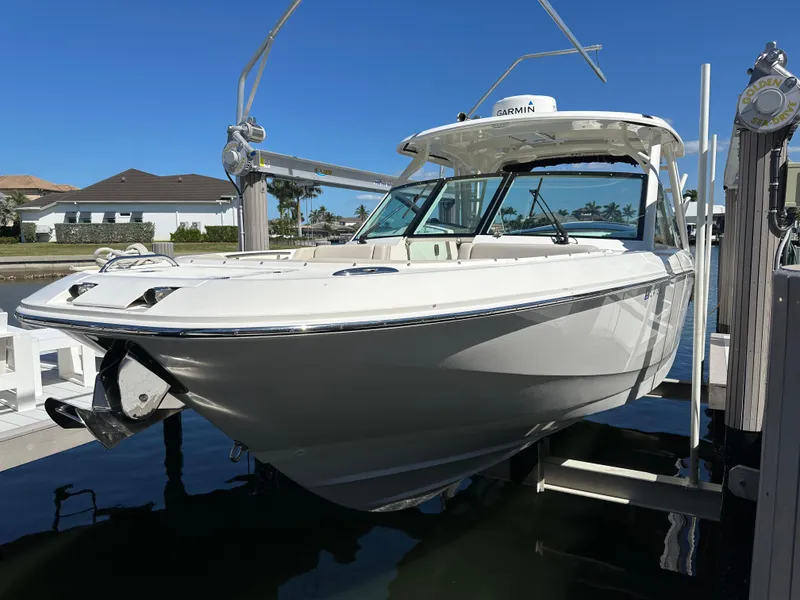 Slide: The Image of 2018 Boston Whaler 320 Vantage boat docked under clear blue sky. - 2