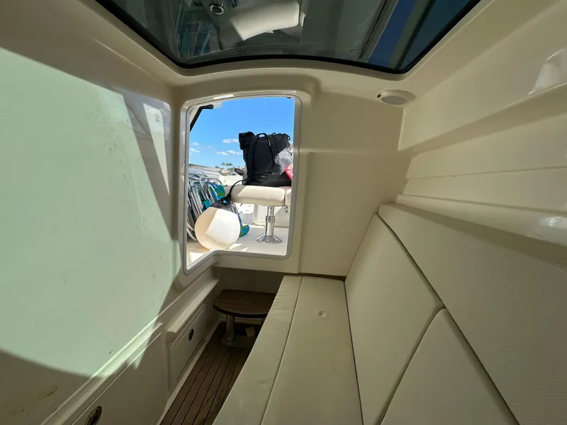 Slide: The Image of 2018 Boston Whaler 320 Vantage boat interior with seating and glass partitions. - 21